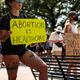 A woman carries a sign declaring abortion a part of healthcare at a rally at the Texas State Capitol on September 11, 2021.